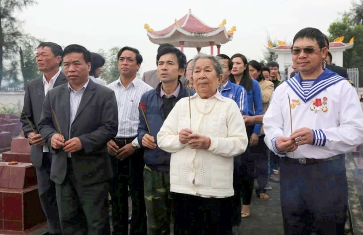 Cơ duyên đã gắn kết mẹ Hồ Thị Đức với những cựu binh Gạc Ma chính từ những lễ tưởng niệm 64 liệt sĩ Gạc Ma trước mộ con trai mẹ là liệt sĩ Trần Văn Phương - Ảnh: Q.NAM