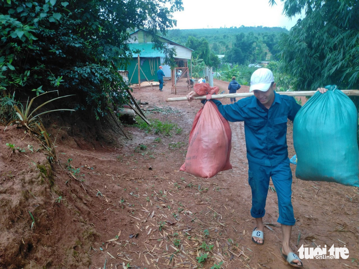 Lực lượng dân quân địa phương hỗ trợ người dân di dời tài sản ra khỏi vùng nguy cơ cao - Ảnh: ĐỨC LẬP