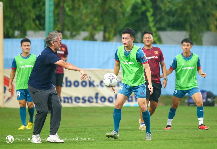 HLV Philippe Troussier hướng dẫn Hoàng Đức trên sân tập - Ảnh: HOÀNG TÙNG