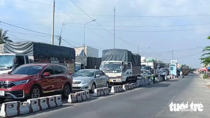 Cảnh ùn tắc, kẹt xe tại đường dẫn xuống phà Đình Khao, phía bờ Vĩnh Long - Ảnh: CHÍ HẠNH