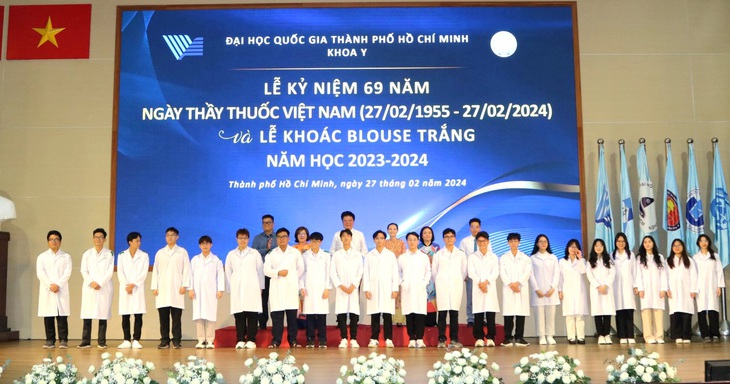 Sinh viên Khoa Y Đại học Quốc gia TP.HCM chụp ảnh cùng thầy cô sau nghi lễ khoác blouse trắng - Ảnh: TTKY