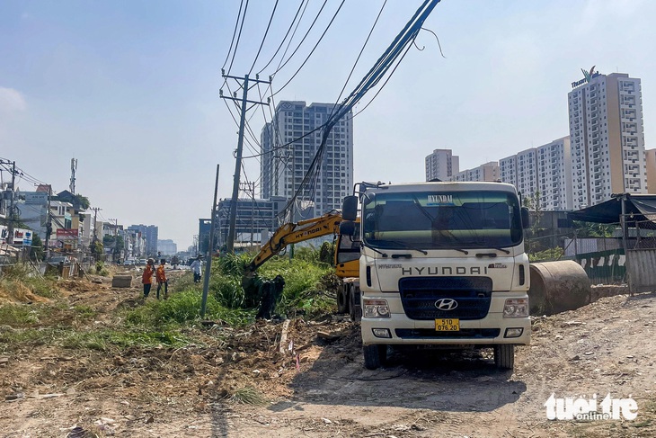 Một mặt bằng phía bên phải đường Lương Định Của hướng từ Trần Não đi An Phú đang được dọn dẹp sáng 21-3. Theo UBND TP Thủ Đức, đoạn này thuộc diện lấn chiếm đất công, hiện UBND TP Thủ Đức đã có kế hoạch cưỡng chế bàn giao cho đơn vị thi công tiếp tục xây dựng - Ảnh: CHÂU TUẤN