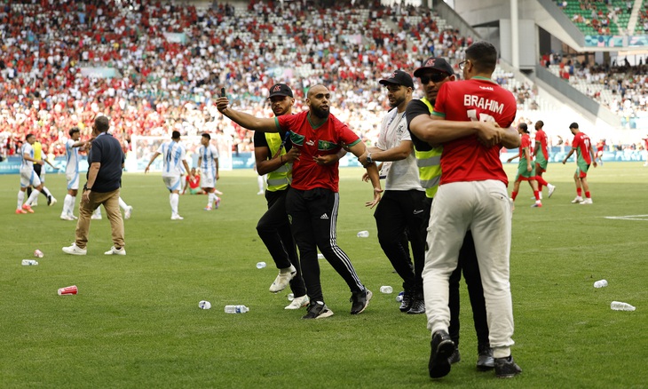 Các CĐV tràn xuống sân trong trận Olympic Argentina - Morocco - Ảnh: REUTERS