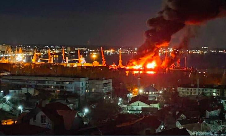 Khói lửa bao trùm bầu trời phía trên cảng Feodosia ở Crimea vào ngày 26-12 năm ngoái, sau cuộc tấn công bằng tên lửa nhằm vào một tàu đổ bộ của Nga - Ảnh chụp màn hình RFE/RL