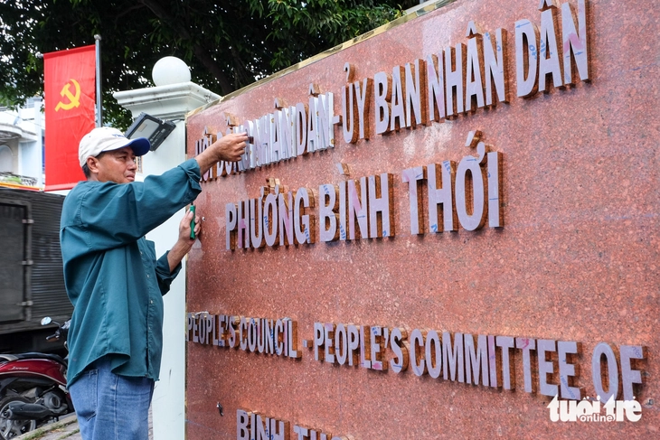 Quận 11 bắt đầu gắn biển tên cho trụ sở phường mới - Ảnh 1.