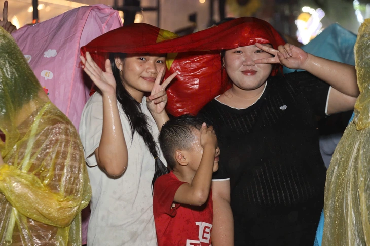 Hình ảnh người dân TP.HCM, miền Tây đội mưa xem bắn pháo hoa - Ảnh 2.