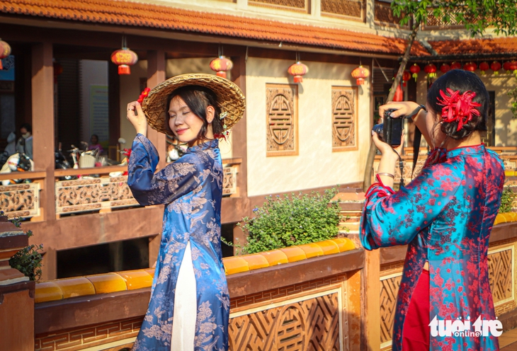Bạn trẻ Đà Nẵng rộn ràng diện áo dài 'săn' ảnh Tết sớm - Ảnh 1.