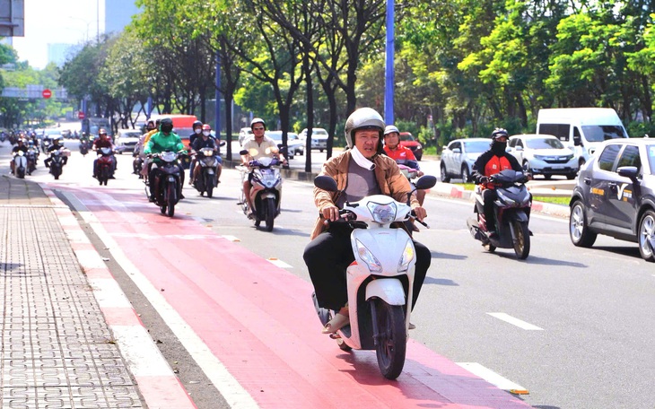 Cảnh sát giao thông xử phạt người chạy xe máy vào làn dành riêng cho xe đạp trên đường Mai Chí Thọ - Ảnh 7.