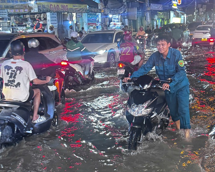 Thanh niên TP . HCM hỗ trợ người dân vượt triều cường an toàn trong năm 2026 - Ảnh 1.