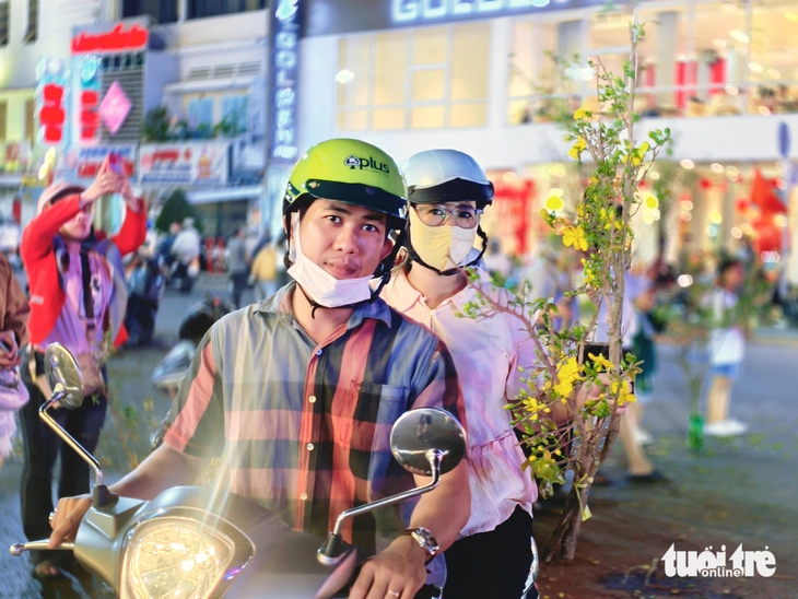 'Chợ' nhánh mai vàng ở Long Xuyên rộn ràng tối 28 Tết, giá rẻ hơn năm trước - Ảnh 4.