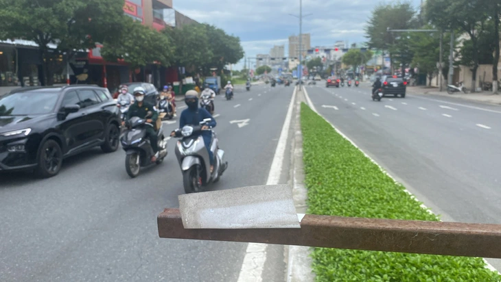 Bạn đọc suýt gặp nạn vì thanh sắt treo băng rôn quá thấp giữa đường - Ảnh 1.