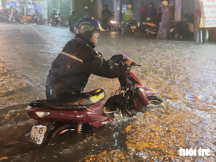 Mưa lớn, nhiều tuyến đường TP.HCM ngập nặng, người dân chật vật về nhà - Ảnh 4.
