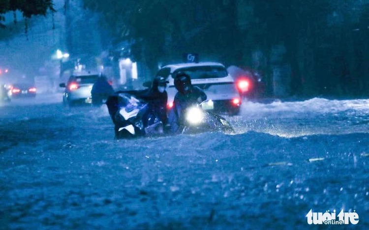 Hanoi residents struggle as heavy overnight rain floods streets