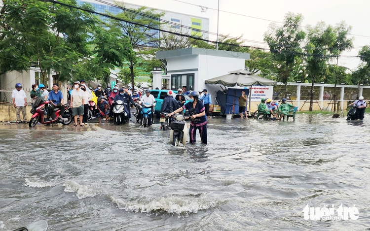 Rain floods street outside suburban Ho Chi Minh City hospital, stranding patients