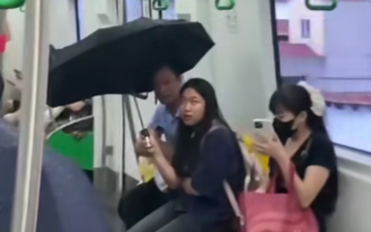 Passengers use umbrellas inside Hanoi metro train due to leaking water