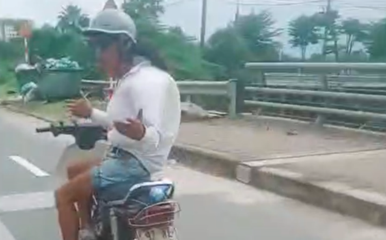 Da Nang police investigate videos of motorcyclist riding hands-free on highway