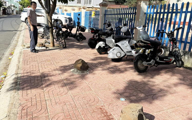 A rocky solution: giant boulders cemented outside Vietnam school to block sidewalk parking