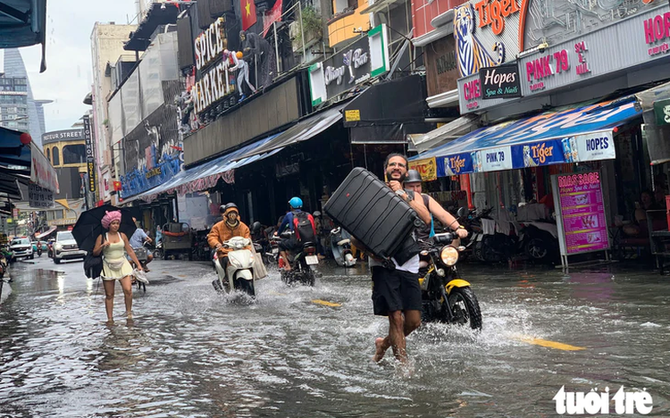Ho Chi Minh City’s ‘backpacker street’, other downtown streets flooded after heavy midday downpour 
