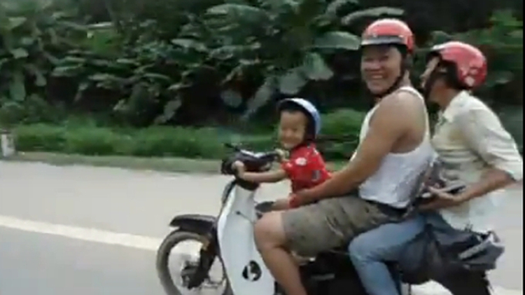 5-year-old boy drives motorbike, carrying 2 adults