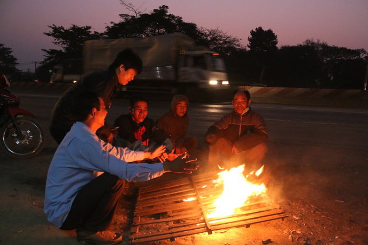 Working people in Saigon build fires in rare cold (photos)