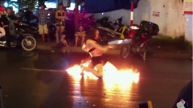 In Vietnam, fire dance performance adds fun - and scare - to sidewalk drinking tables