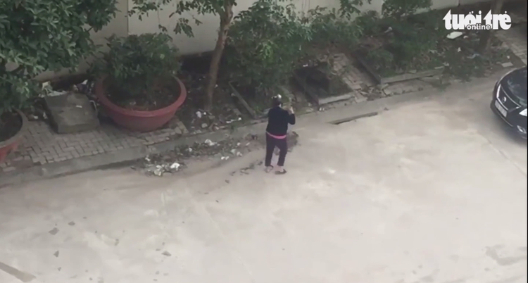 Vietnamese woman fined after being caught sweeping trash down sewer