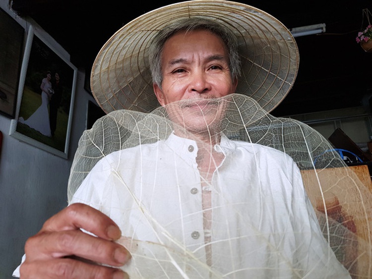 Vietnamese man makes traditional conical hat from almond leaf
