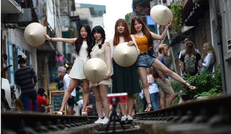 Hanoi begins clearing famed railway cafés after train pulls emergency brake to avoid tourists