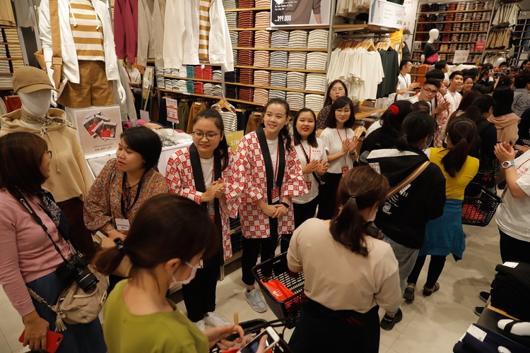 Shoppers wait in long queues during grand opening of Vietnam’s first Uniqlo store