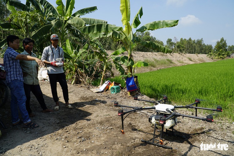Crop dusting drones roam the skies above southern Vietnam’s paddy fields
