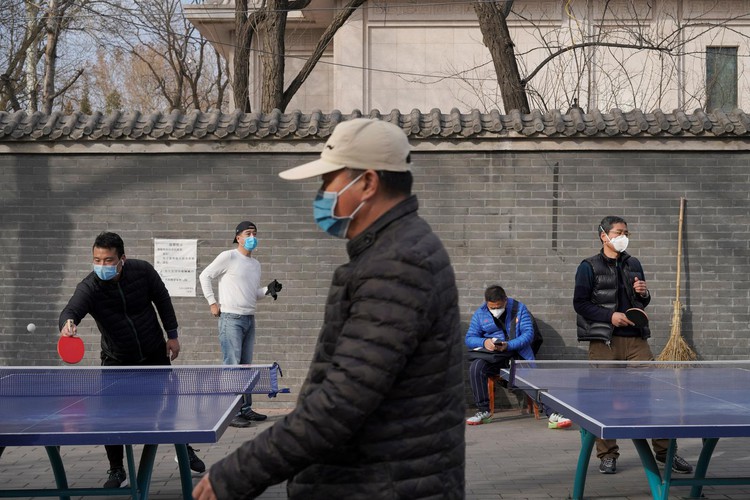 China reports fall in new coronavirus cases but concerns grow over spread elsewhere