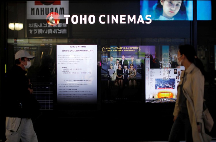 Tokyo restricts movement to combat virus, some folk carry on as usual