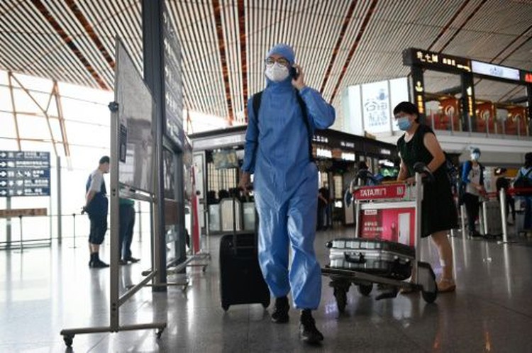 Beijing cancels flights, shuts schools over new virus outbreak