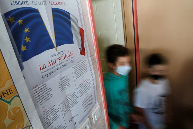 Textbooks and face masks, Europe's children return to school