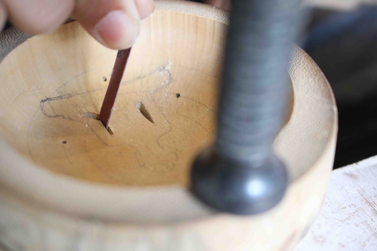 Vietnamese man carves spiritual icons on bamboo nodes