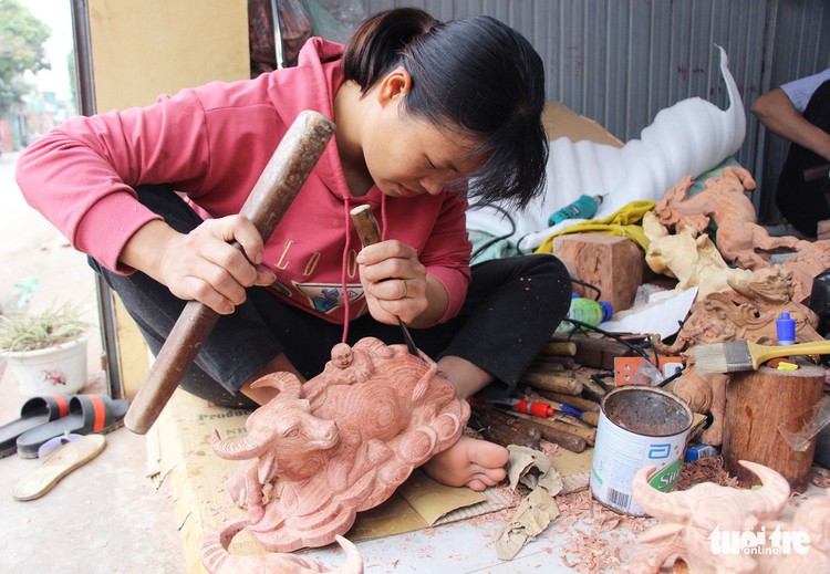 Northern craft villagers add wooden, clay buffalo to ornament market ahead of Tet