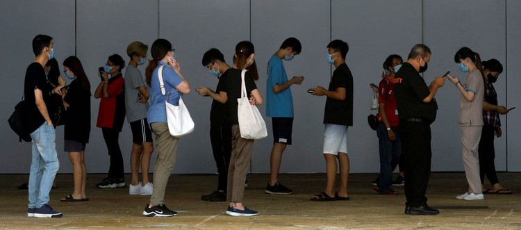 Singapore advises unvaccinated people to stay home as cases rise