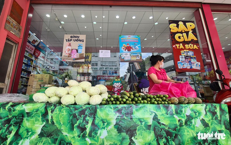 As locals scour markets for veggies, Saigon drugstores sell groceries on sidewalks