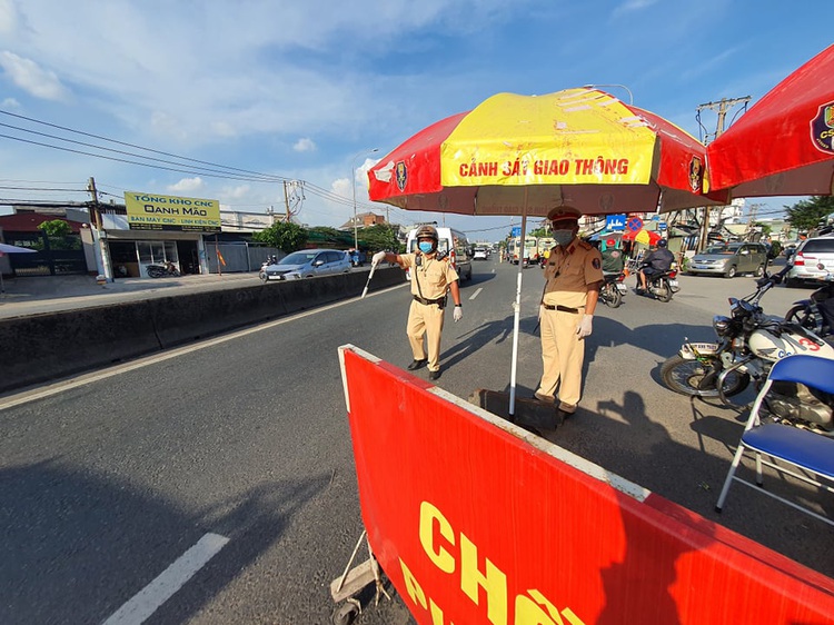 Which businesses, services are allowed to operate during strict social distancing in Ho Chi Minh City?