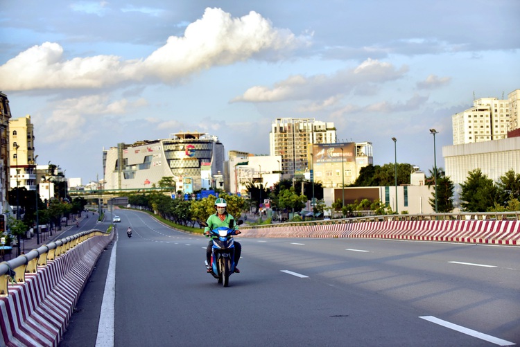 Who are allowed to leave home during outdoor travel restrictions in Ho Chi Minh City?