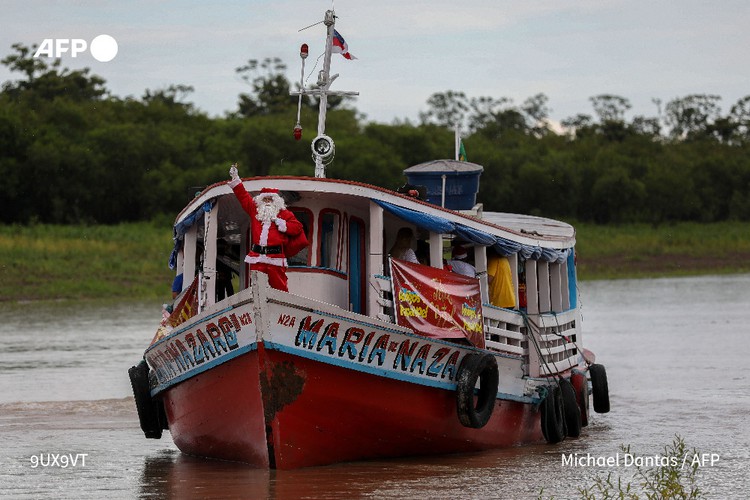 In Brazil's sweltering Amazon, Santa swaps his sled for boat