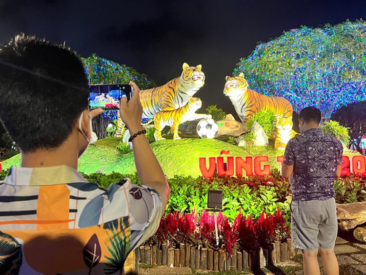 Young people pose with zodiac animal to pray for good luck in Vietnam