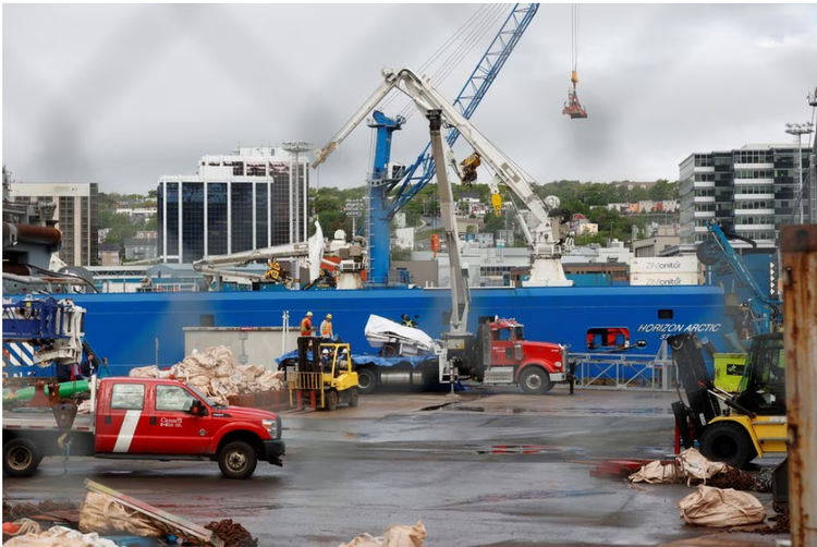 Presumed human remains and shattered Titanic submersible returned to shore