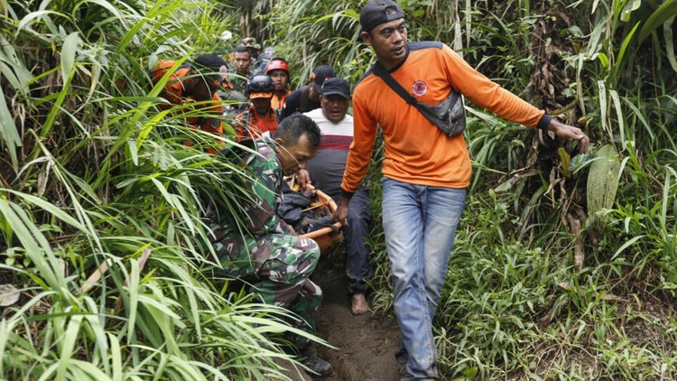 Indonesian rescuers race to find 12 missing after eruption