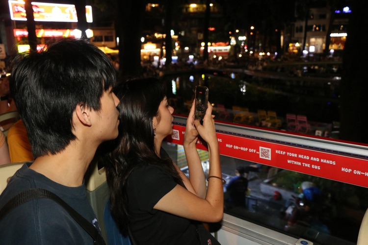 Exploring sleepless Ho Chi Minh City via all-night double-decker bus tour