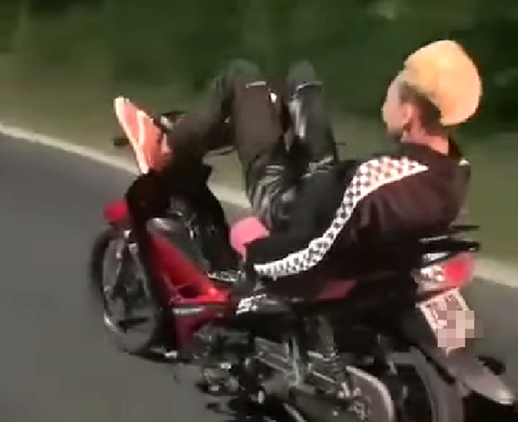 Teenager fined $149 for riding motorcycle with legs, wearing no helmet in south-central Vietnam