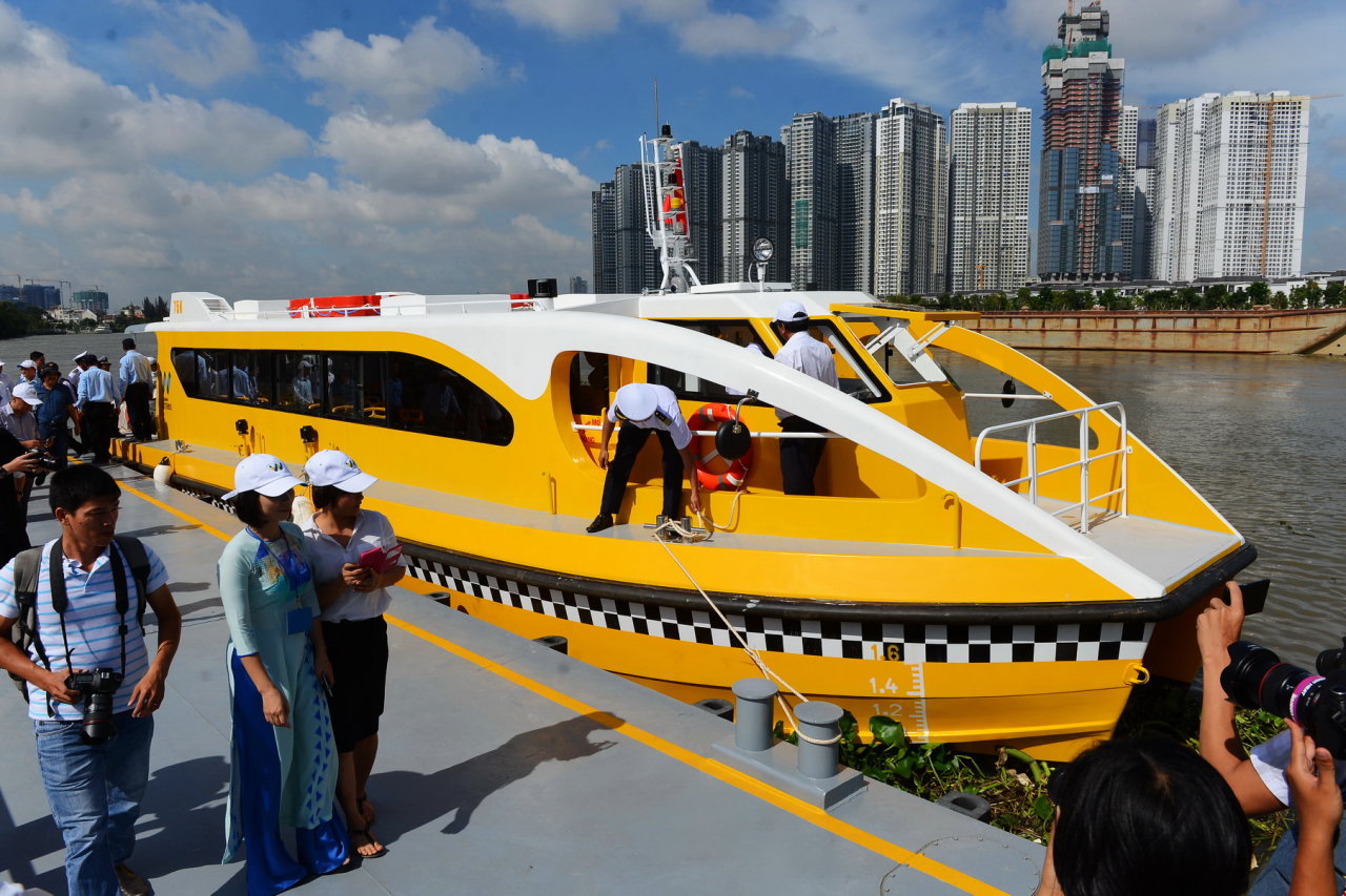 A water bus docks at a stop during its journey.  