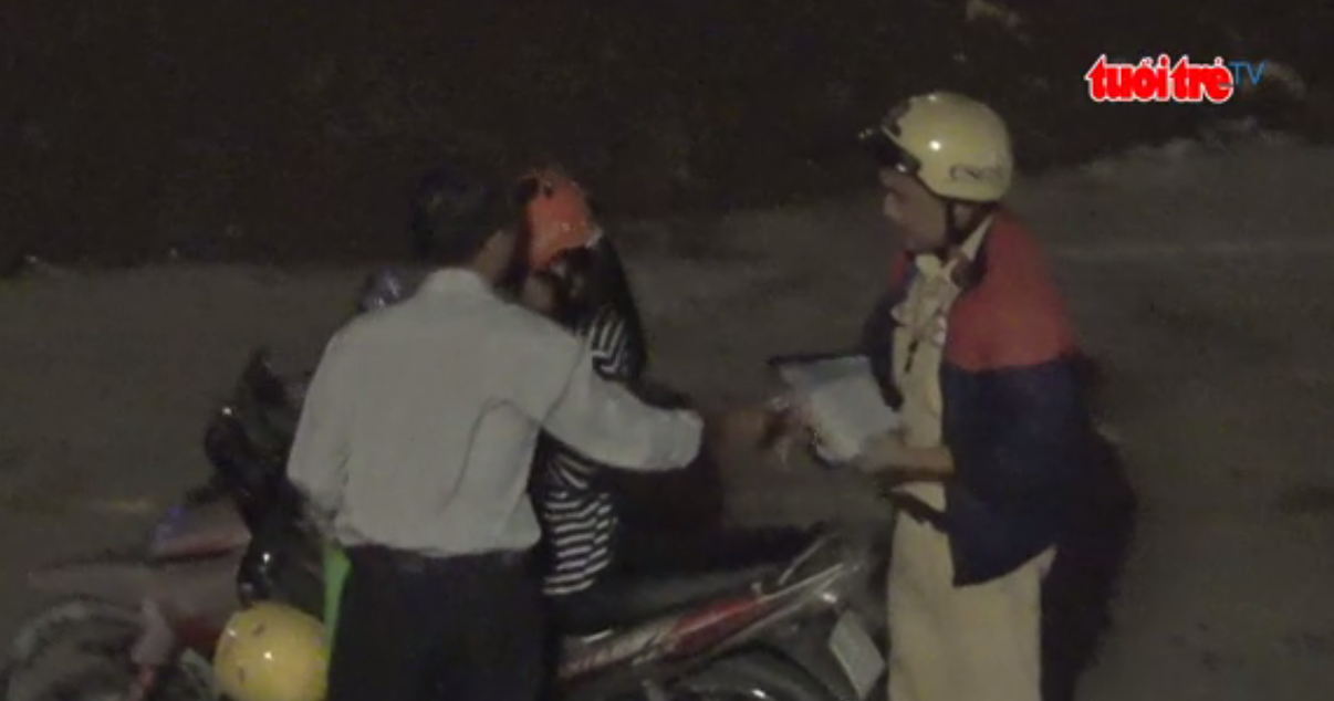 A traffic cop collects ‘fine’ from an offender near Tan Son Nhat Airport.