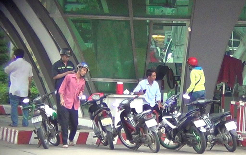 Traffic offenders walk into the security guard cabin of the Amata Industrial Park to meet traffic officers.