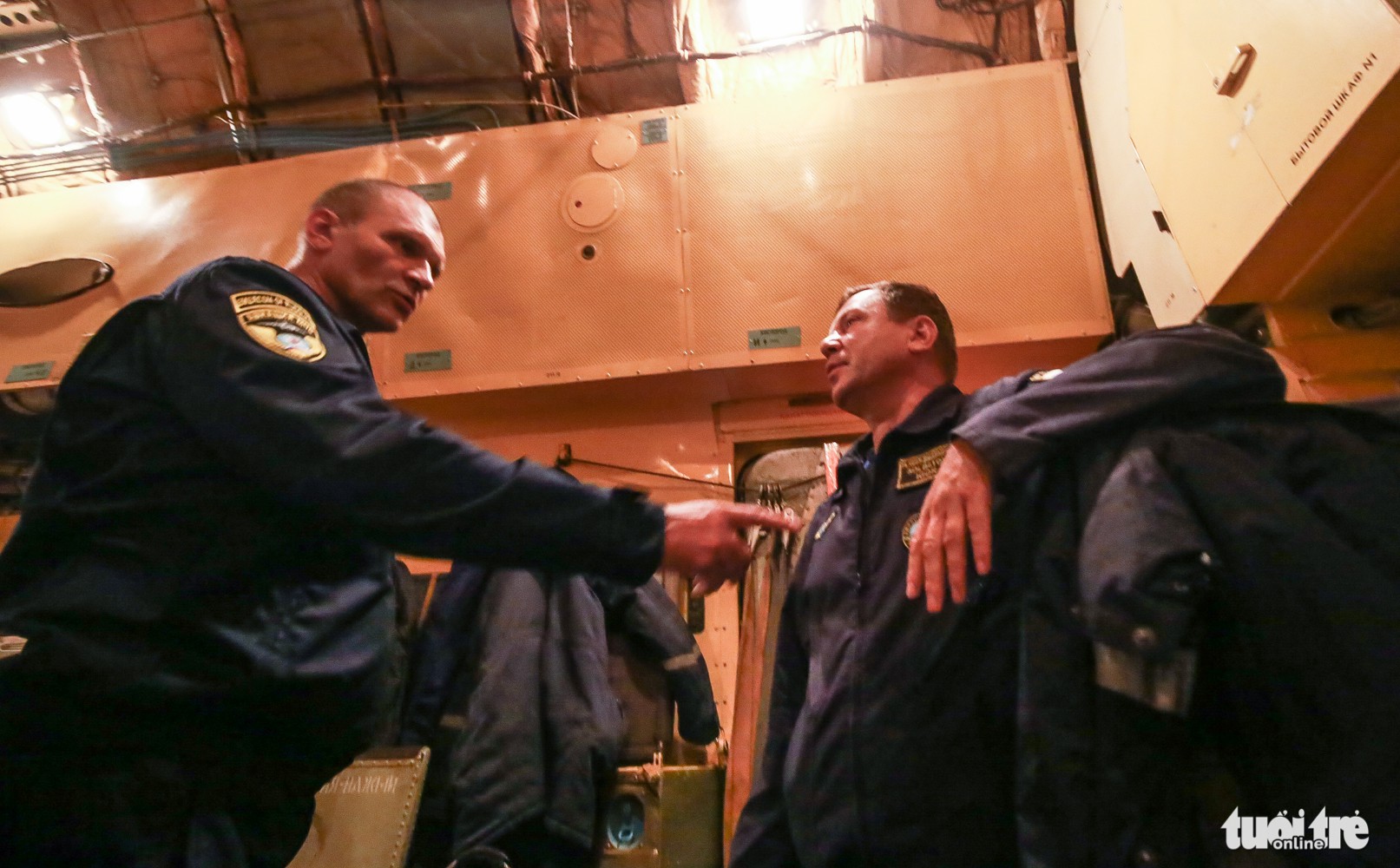 Two crew members from the Russian aircraft chat with each other while waiting for the goods to be unloaded. Photo: Tuoi Tre